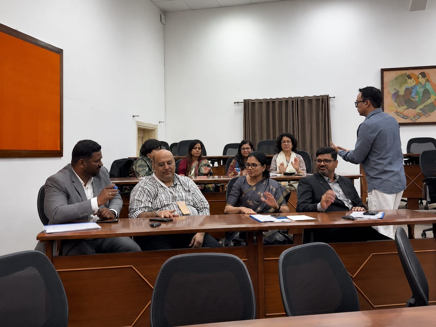 Participants seated around a boardroom table during a YAM Training discussion
